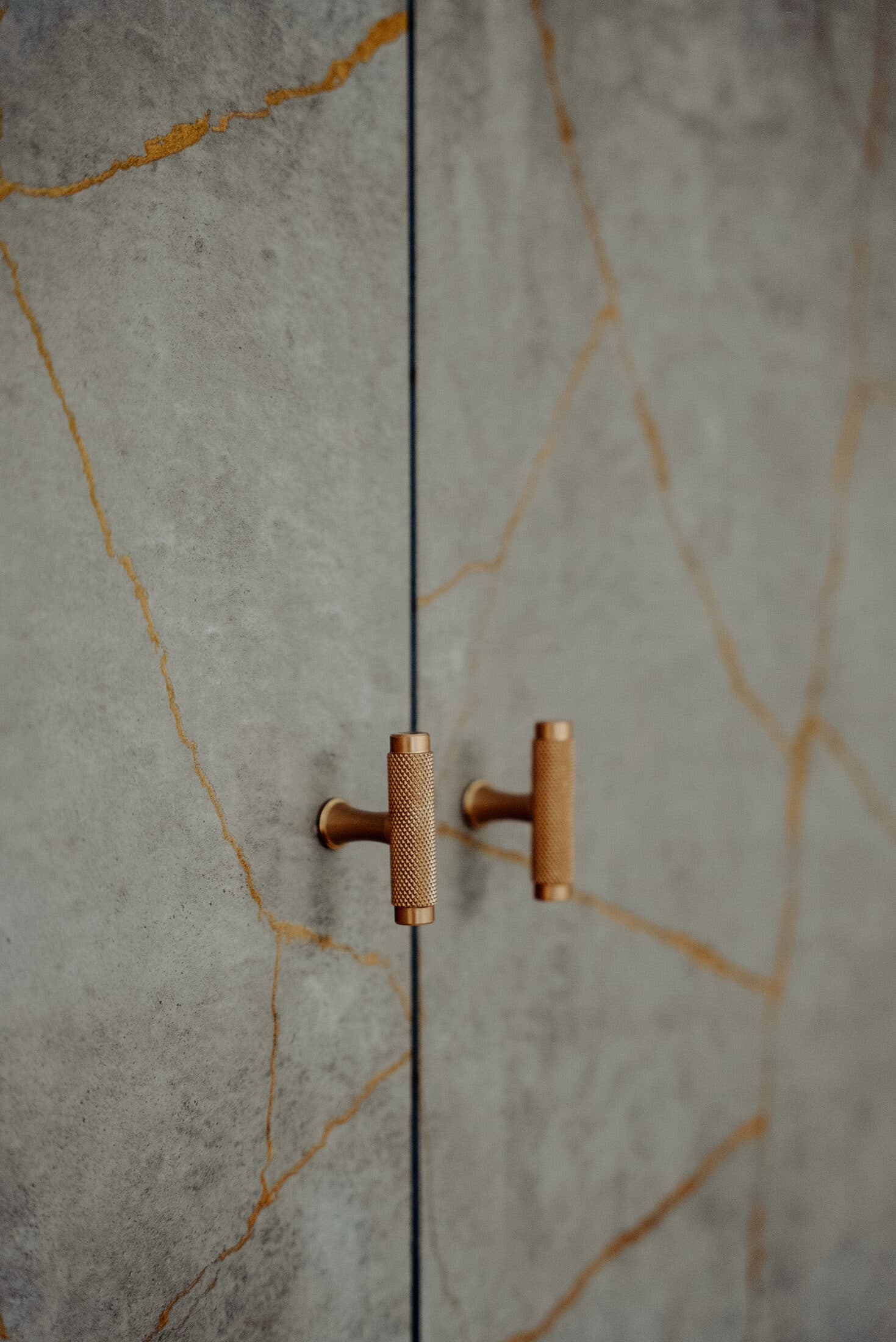 Close up of brass knurled cabinet handles by Sunny Interiors